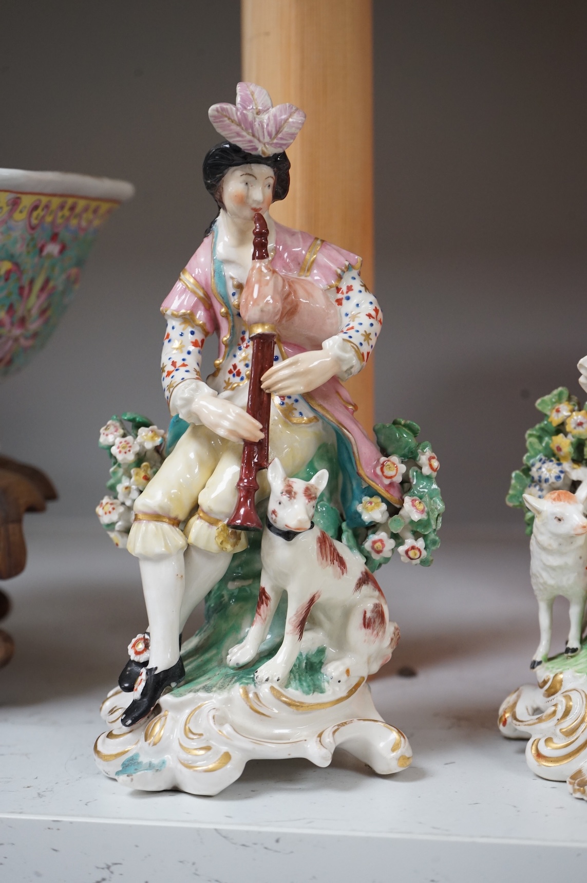 A pair of Derby porcelain figures of musicians, and another of a lady and cat, late 18th century, largest 18cm high